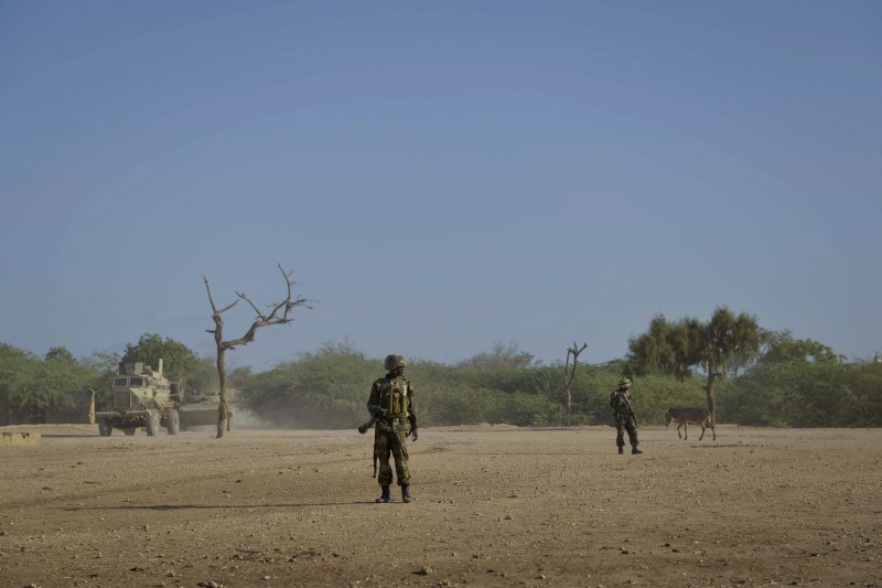 African Union soldiers, as part of the Ugandan contingent of AMISOM, conduct a foot patrol on April 29 through the town of Qoryooley, Somalia (AU UN IST PHOTO / Tobin Jones)