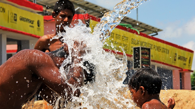 Villagers taking shower under a solar-powered water pump at Dharnai village in Bihar, India (Pic: Avik Roy)