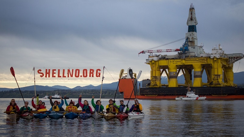 Activists paddle up to Shell's Polar Pioneer rig in Seattle, to protest Arctic drilling (Flickr/sHell No! Action Council/Charles Conatzer)