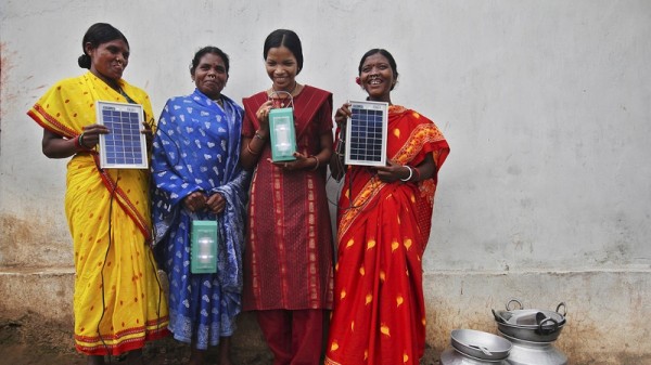 After five months training in solar power engineering, four women in Tinginaput, India show off their lamps (Flickr/DFID)