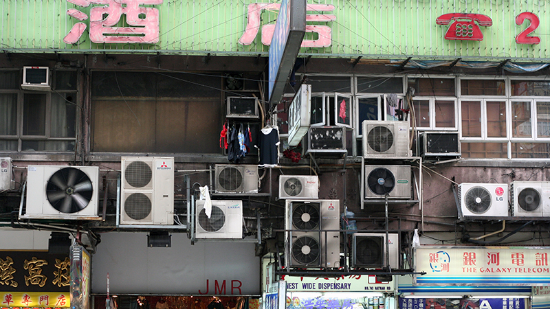 Air conditioning units hang from the side of a building in Hong Kong (Flickr/ Niall Kennedy)