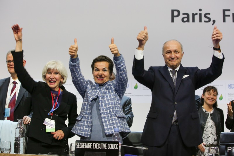 Laurence Tubiana (l), Christiana Figueres (c) and Laurent Fabius (r) celebrate approval of the Paris climate agreement (Pic: Kiara Worth/IISD-ENB) 