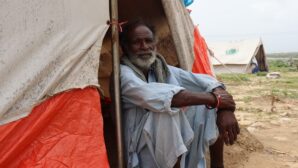 Man in tent after floods in Pakistan
