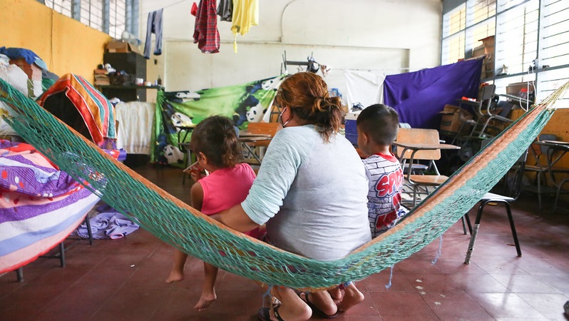 Woman and children sit in hammock