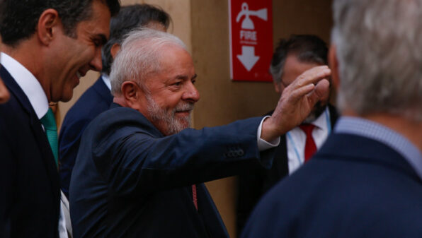 Lula da Silva with a hand raised to greet onlookers