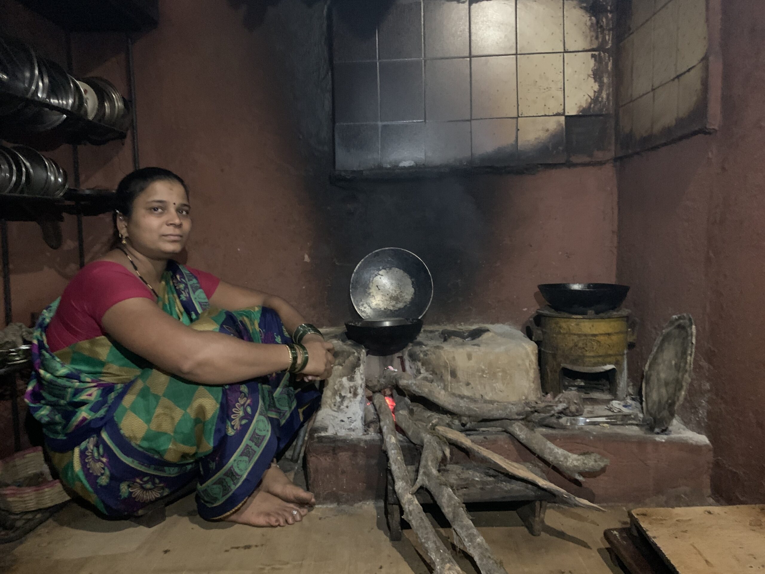 Sheetal Kelgane sitting in her kitchen beside a firewood stove in Maharashtra state, India. Revealed: Cookstove offsets produce millions of junk carbon credits