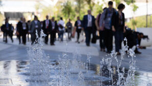 a water feature and people in suits walking through the Cop28 climate conference venue