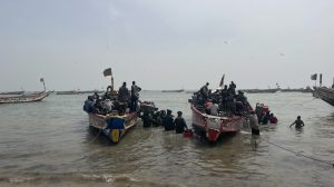 Two boats with fishermen in Mbour, Senegal, where sea level rise is impacting local fisheries, ust miles from the hotel resort of Saly, supported by the World Bank climate funds.