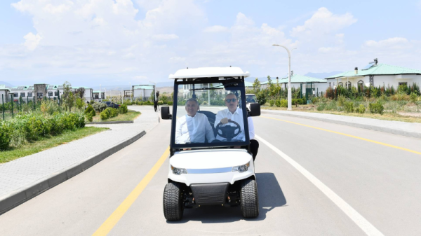 Azerbaijan President Ilham Aliyev tours the Agali "smart" village in an electric cart. Photo: Azerbaijan Presidency