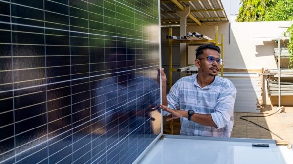 Nitesh Patel, a small business owner, shows an Indian-made solar panel in his warehouse in Bhuj, Gujarat (Photo credit: Mitul Kajaria)