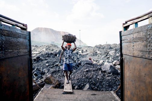 Workers load coal on a truck near an open-cast mine, on the outskirts of Dhanbad.